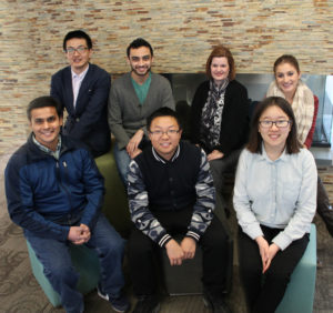 The Golden Research group poses together by the School of Nursing fireplace