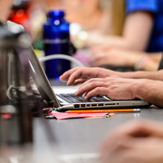 Hands typing on a laptop keyboard
