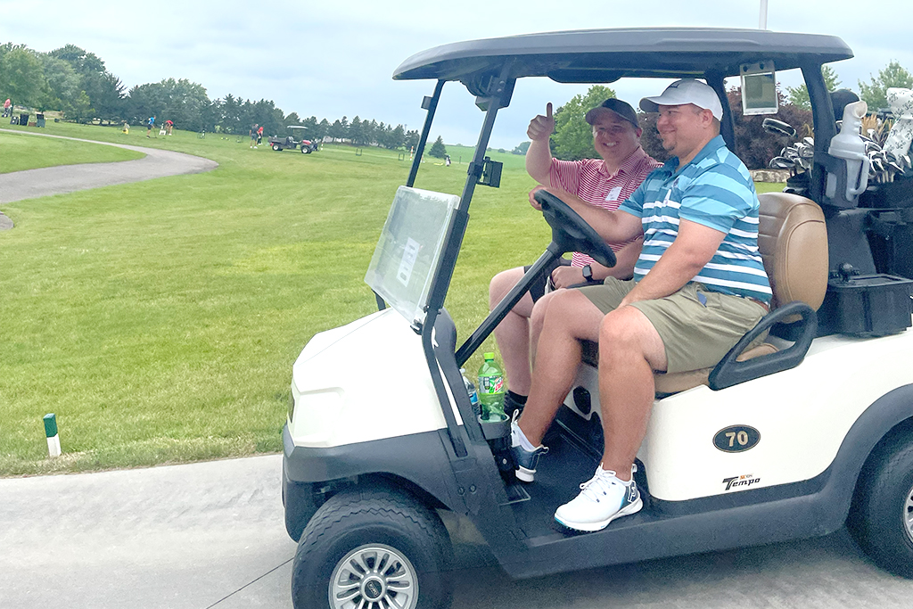 Tyler Prickette and Sean Baltes head off on a golf cart