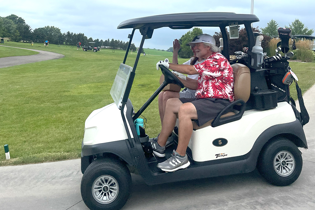 Jeff Johnson and others head off on a golf cart