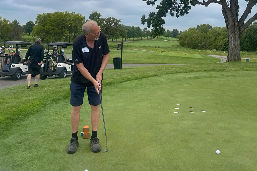 A male golfer tees off