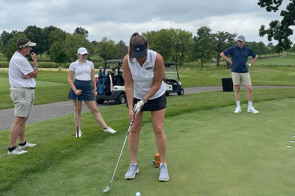 A female golfer tees off