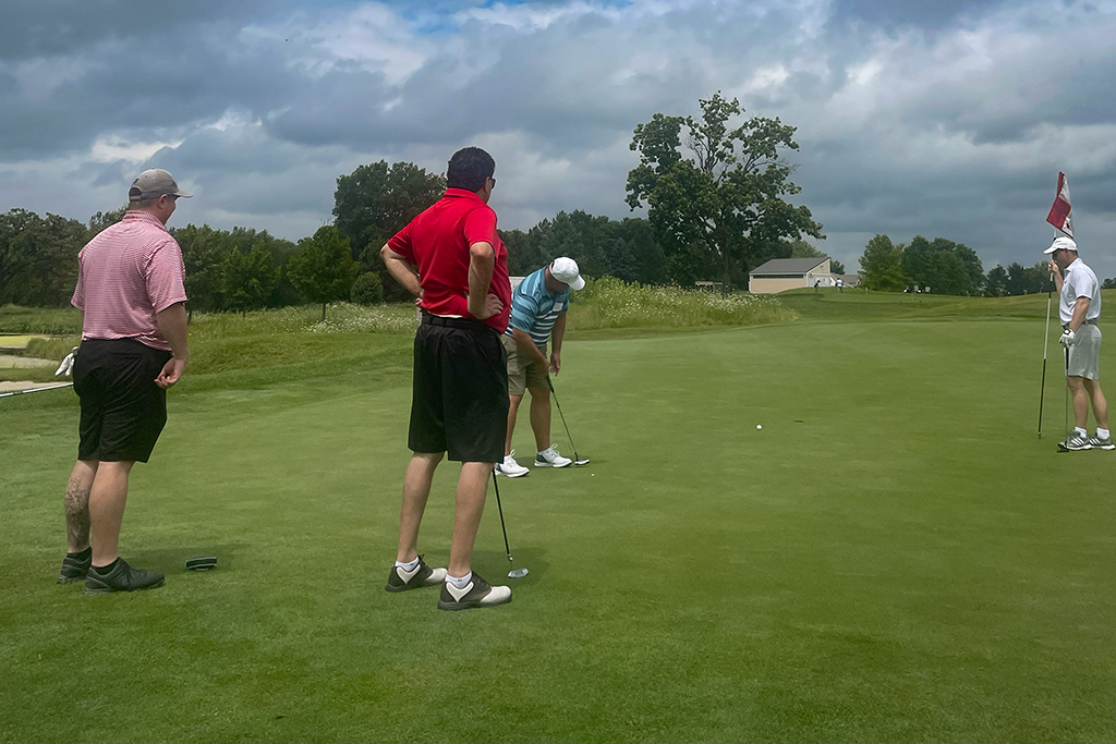 Tyler Prickette, Sean Baltes, Rocky LaDien, and Jason Lau looking at the golf course