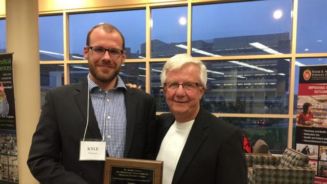 Kyle Wagner holding his award with Dick Peterson