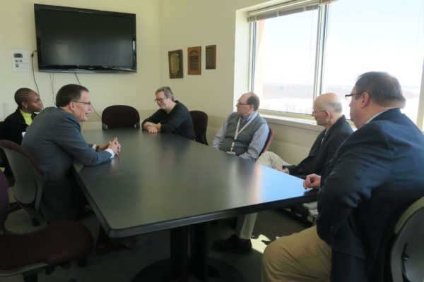 Provost Karl Scholz speaking with staff in a meeting