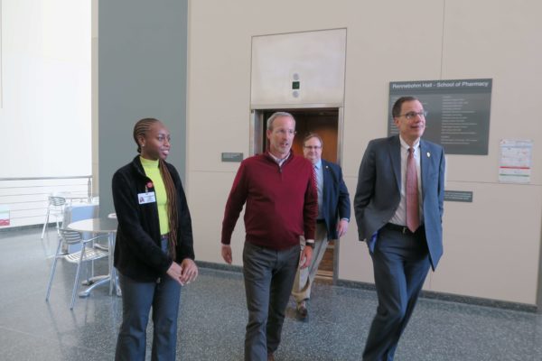 Provost Karl Scholz walking through Rennebohm Hall with Dave Mott, Cierra Brewer, and Dean Steve Swanson