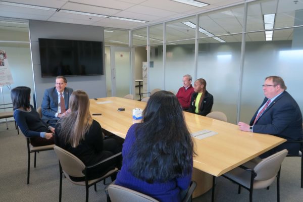 Provost Karl Scholz listening to Michelle Chui during a meeting with faculty and graduate students