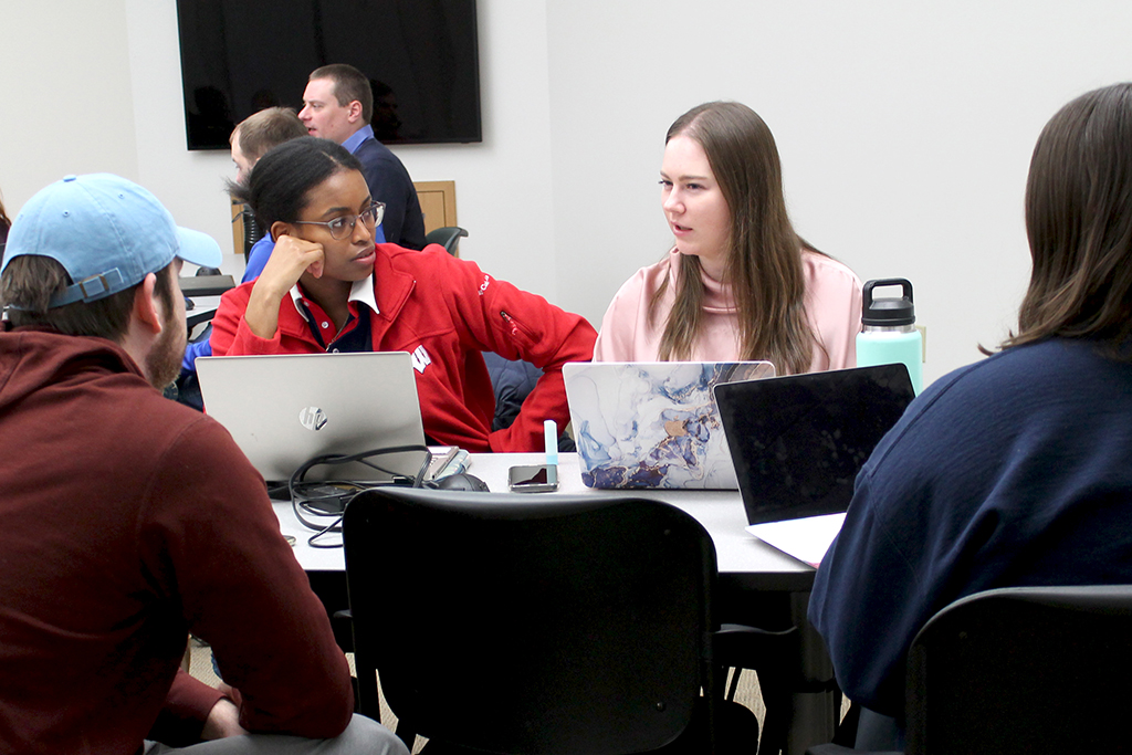 Maria Hill and Kara Graves talk during class