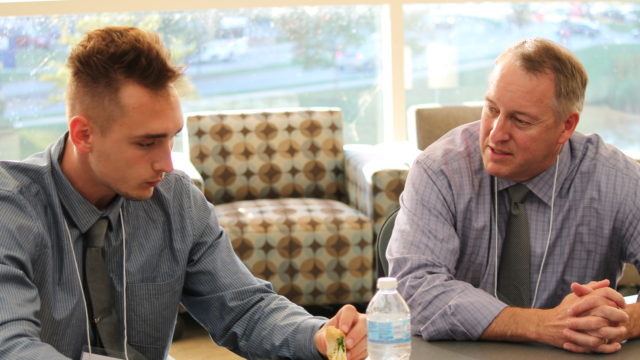 Brett Kelly at table with Jalen McCartin