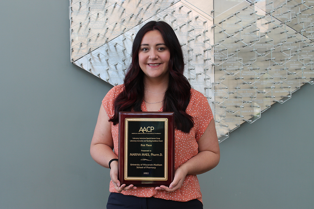 Marina Maes holds a plaque