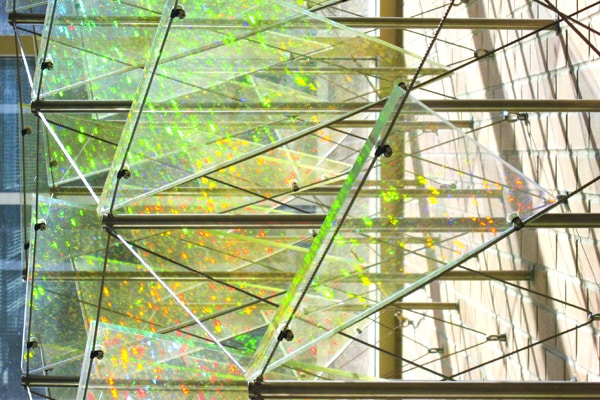 Colorful reflections on glass wall sculpture in Rennebohm Hall