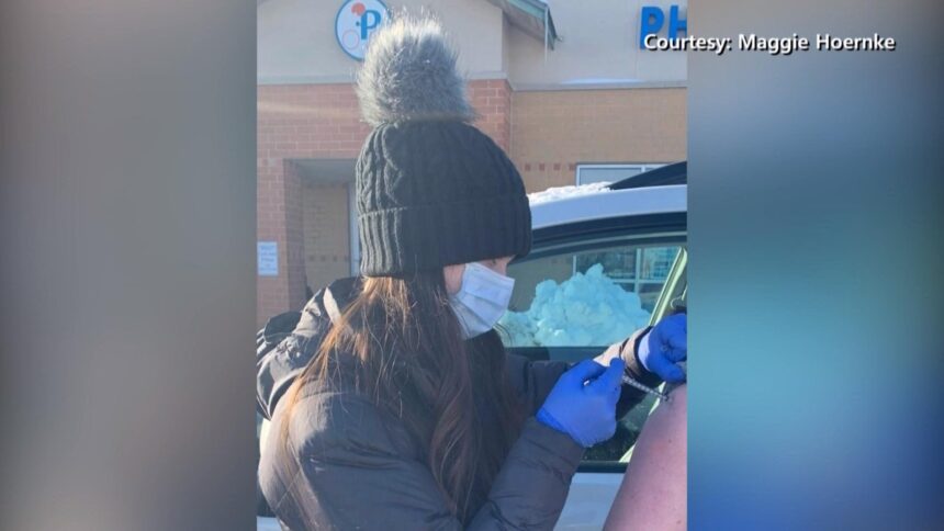Maggie Hoernke administering covid vaccinations to patients outside