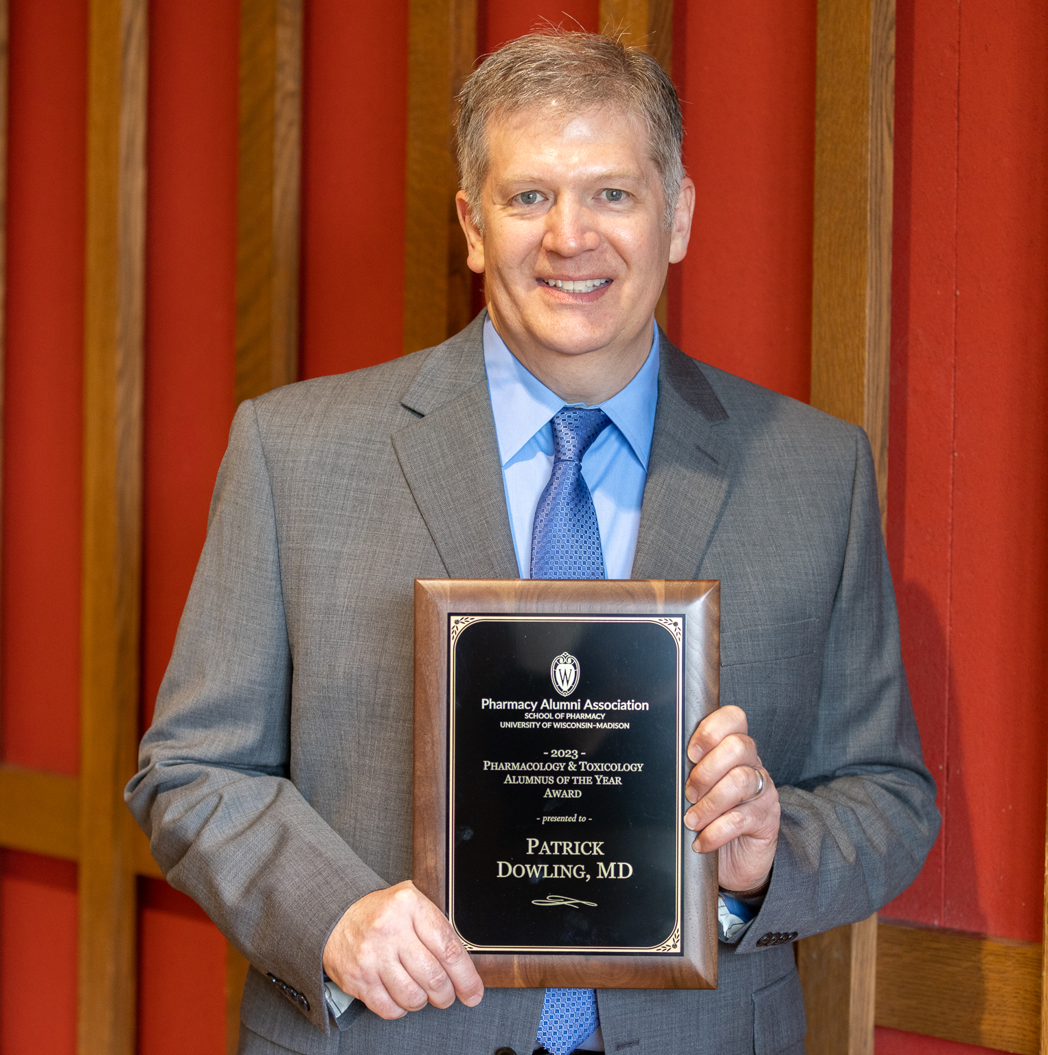 Pat Dowling holding his award plaque.