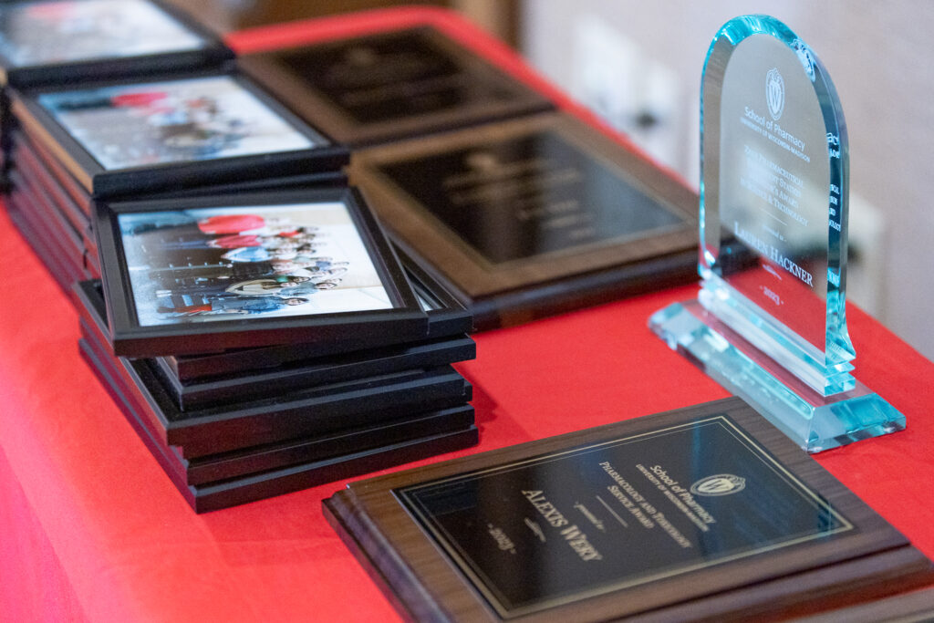 PharmTox class photos and awards sitting on a table.