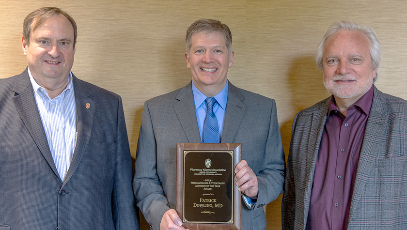 Steve Swanson and Jeff Johnson with Patrick Dowling holding his award