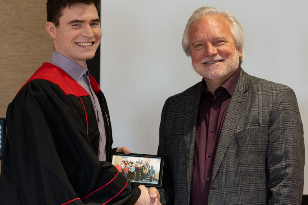 Jeff Johnson and a PharmTox graduate pose for a photo.