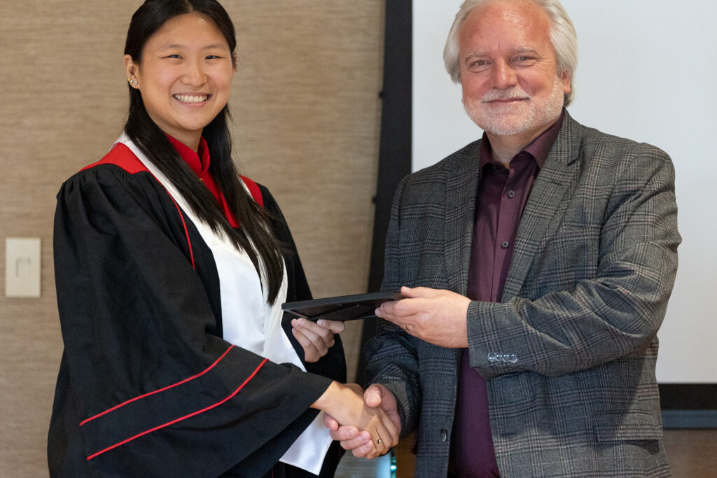 Jeff Johnson and a PharmTox graduate pose for a photo.