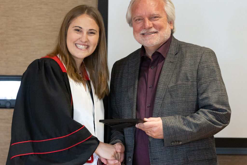 Jeff Johnson and a PharmTox graduate pose for a photo.