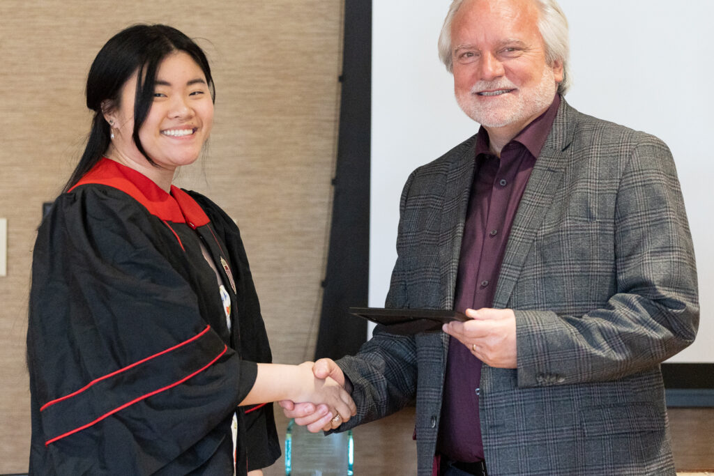 Jeff Johnson and a PharmTox graduate pose for a photo.