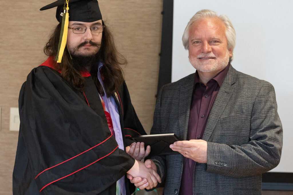 Jeff Johnson and a PharmTox graduate pose for a photo.