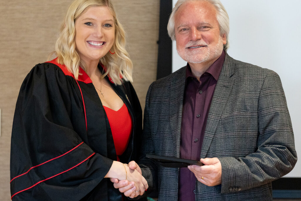 Jeff Johnson and a PharmTox graduate pose for a photo.