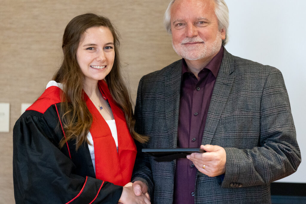 Jeff Johnson and a PharmTox graduate pose for a photo.