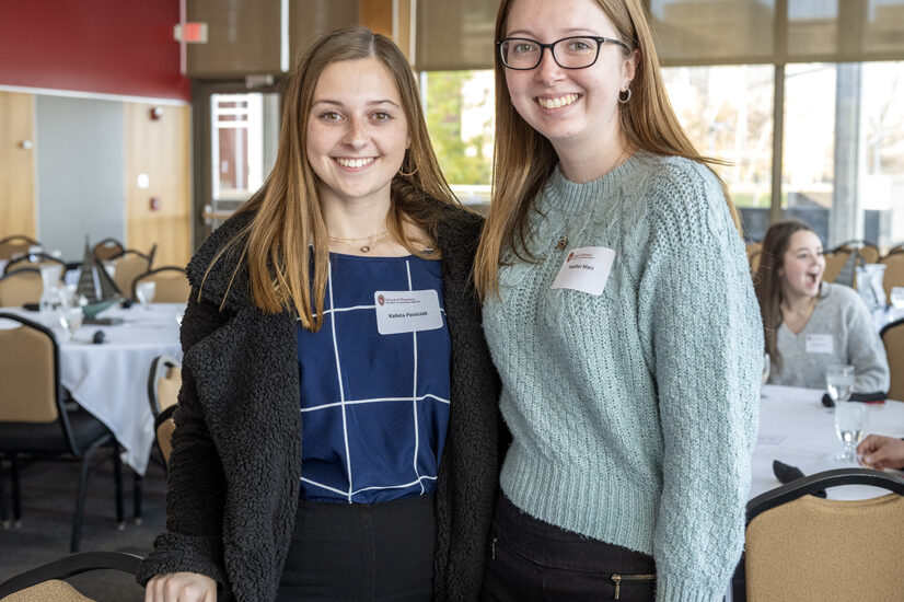 Kalista Paszczak and Heather Marz standing next to each other by round table