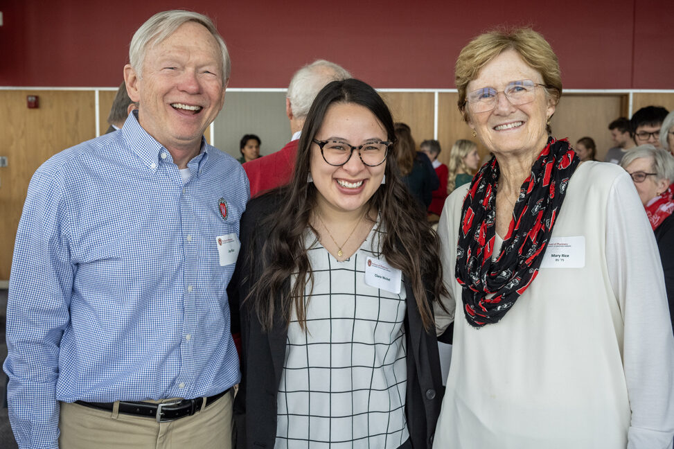 Clara Nickel smiling in between Alumnus Mary Rice and Jay Rice