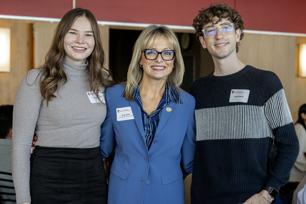 Beth Martin standing between Abby Opsal and Jacob Deheck