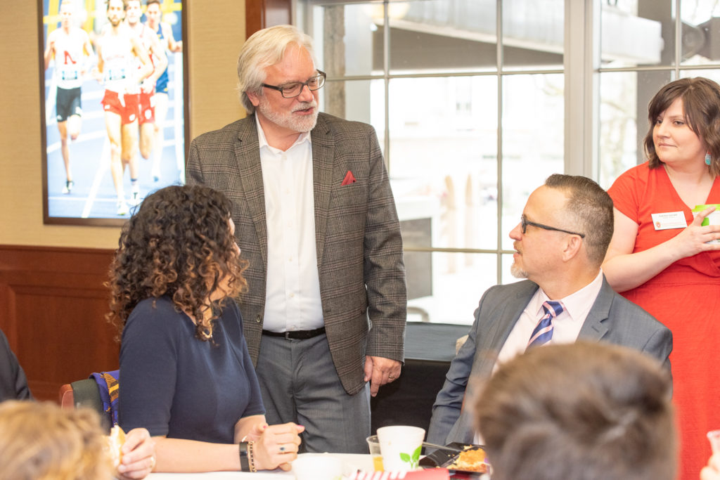 The conversations during the breakfast engage students and school faculty.