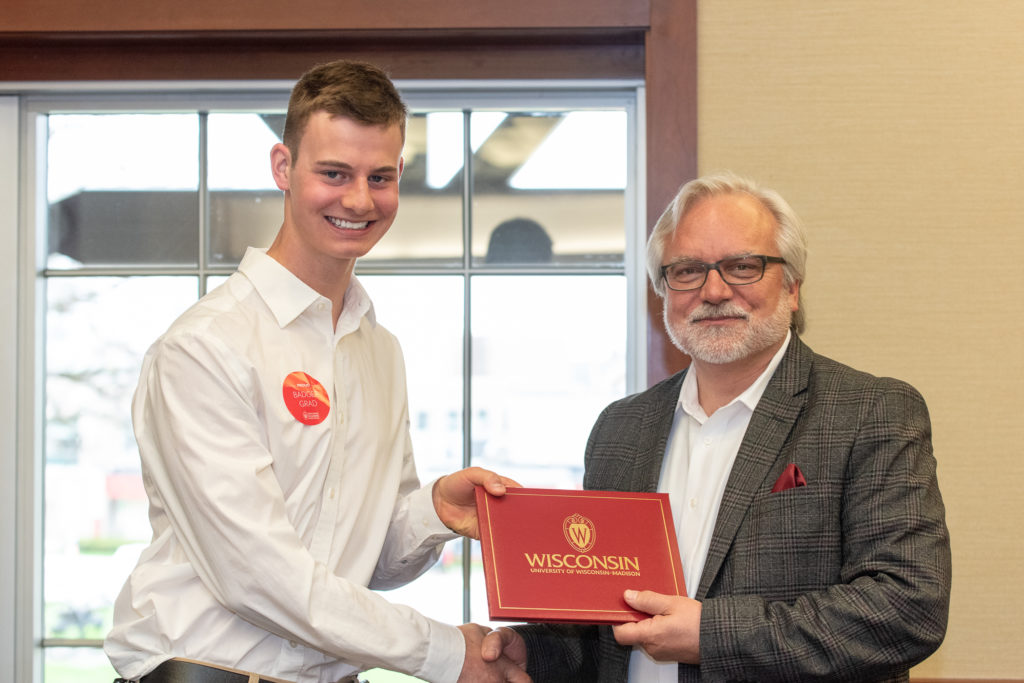 Students receive their diploma from Professor Jeff Johnson.