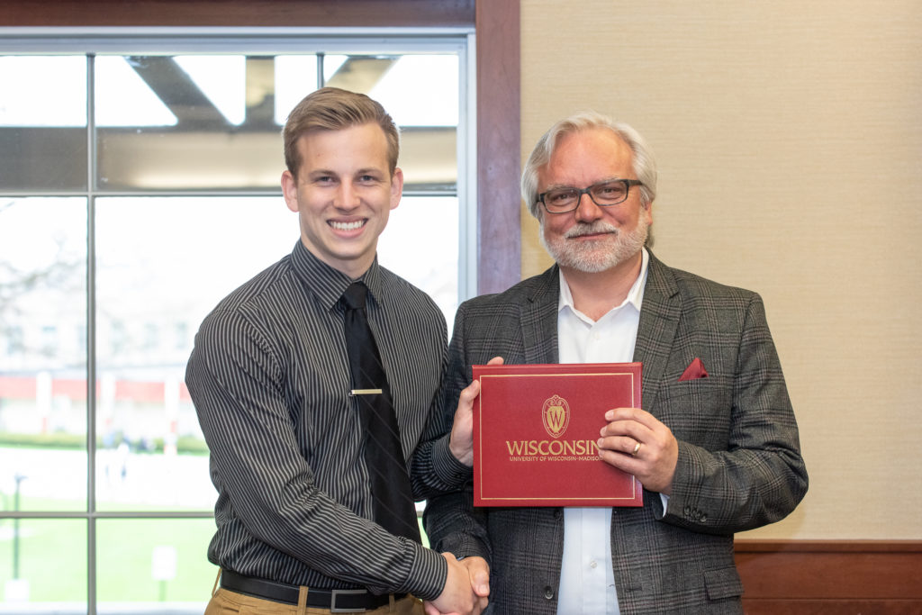 Students receive their diploma from Professor Jeff Johnson.