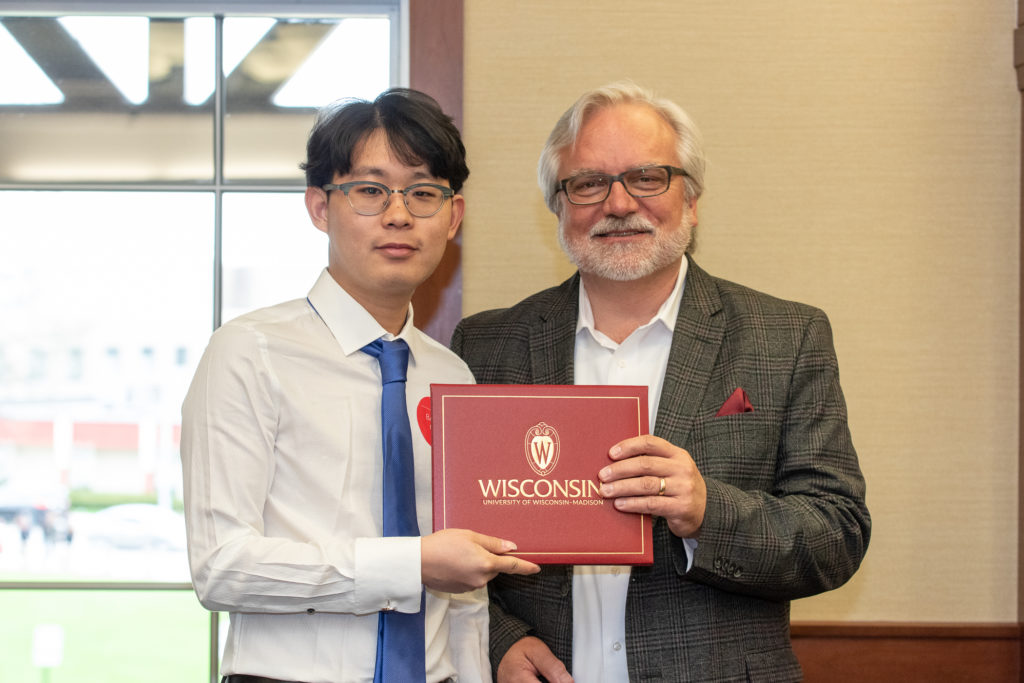 Students receive their diploma from Professor Jeff Johnson.