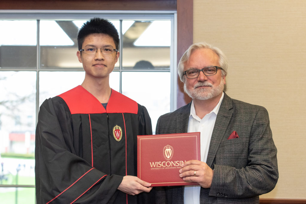 Students receive their diploma from Professor Jeff Johnson.