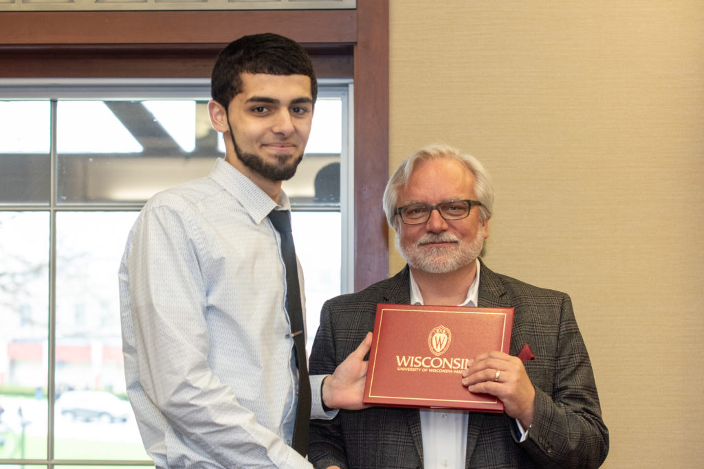 Students receive their diploma from Professor Jeff Johnson.