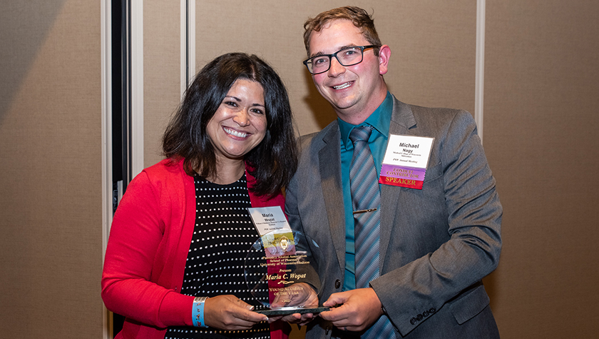Maria Wopat and Michael Nagy holding the Young Alum of the Year Award