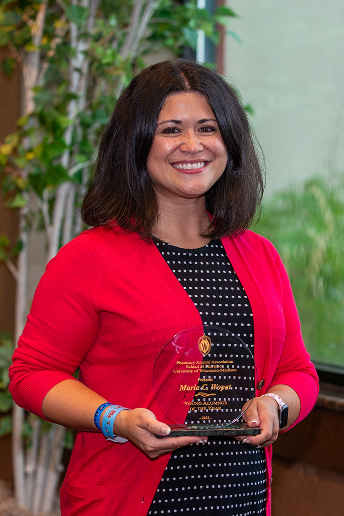 Maria Wopat holds her 2022 Young Alum of the Year award.