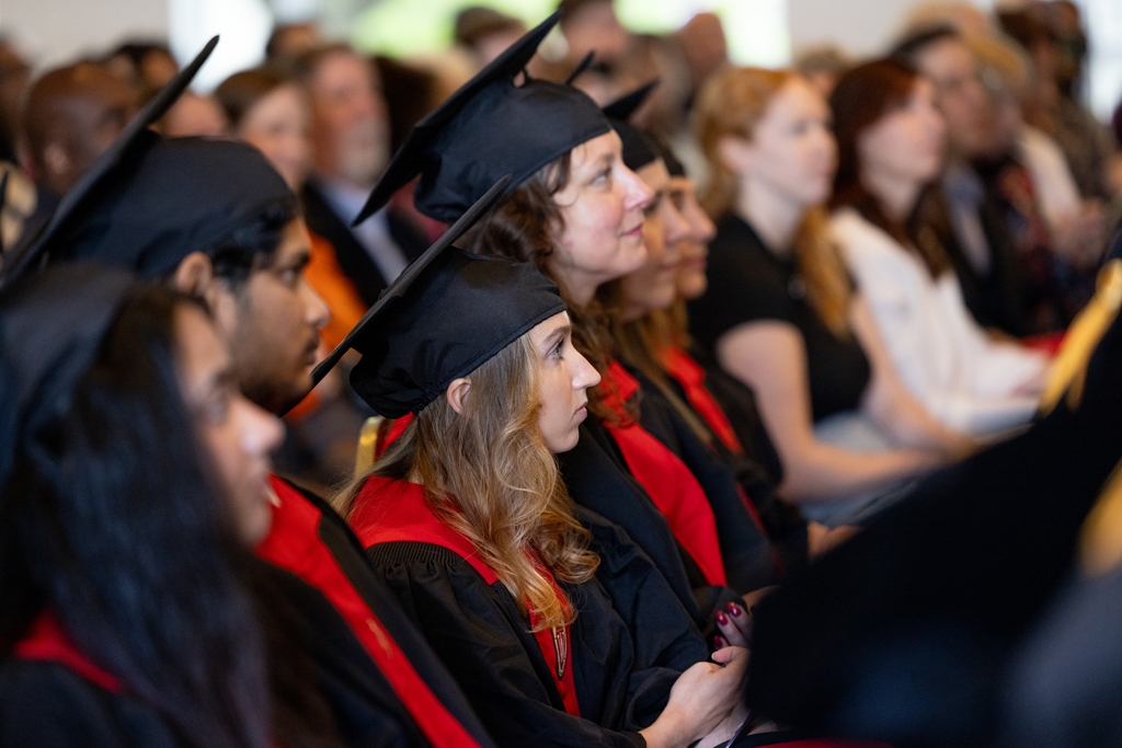 Graduates listen to speakers