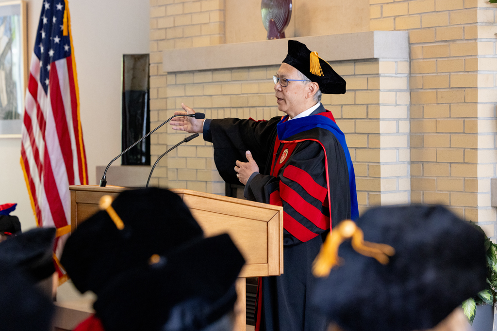 Roger Tung speaks at the podium