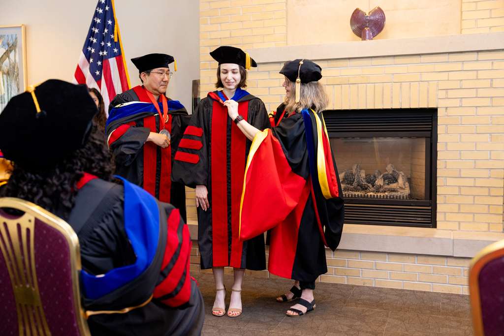 A graduate receives her hood