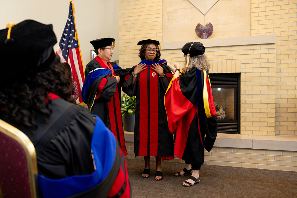 A graduate receives her hood