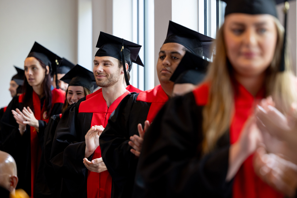 Graduates lines up for the hooding