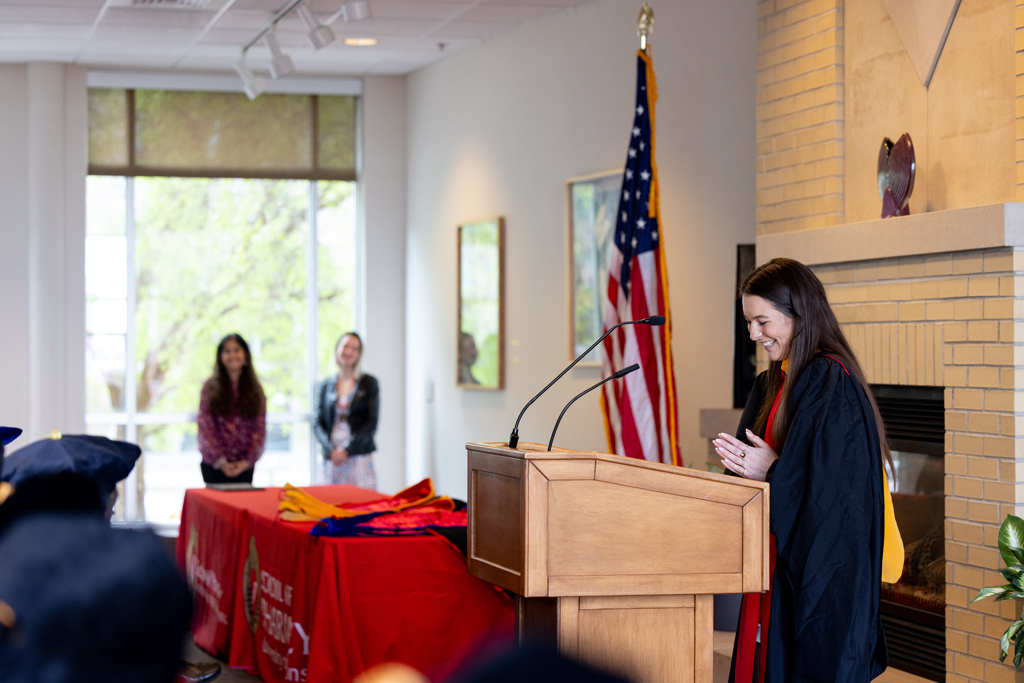 Mika Hess speaks at the podium