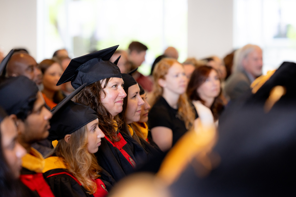 Graduates listen to the speakers