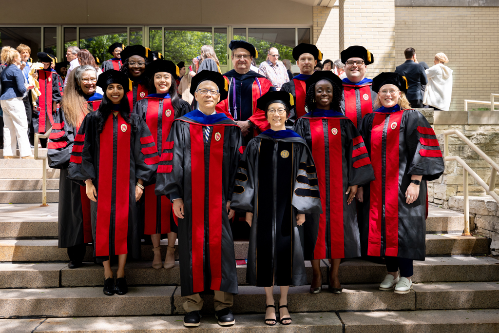 Faculty and graduates pose with Roger Tung