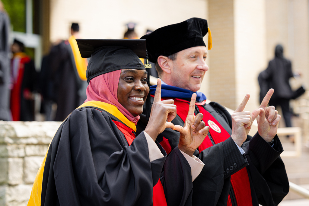 Eric Buxton poses with a graduate
