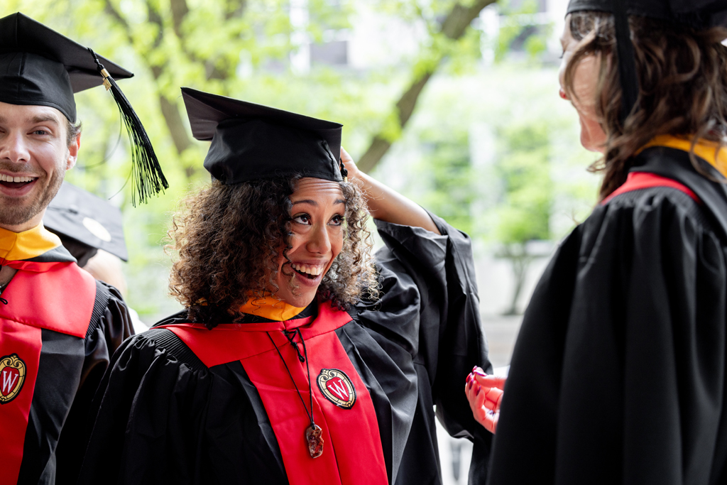 Graduates smile outside