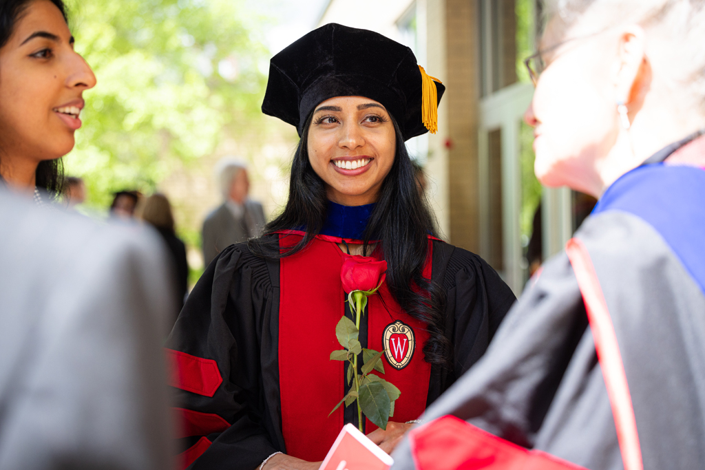 Graduates smile outside
