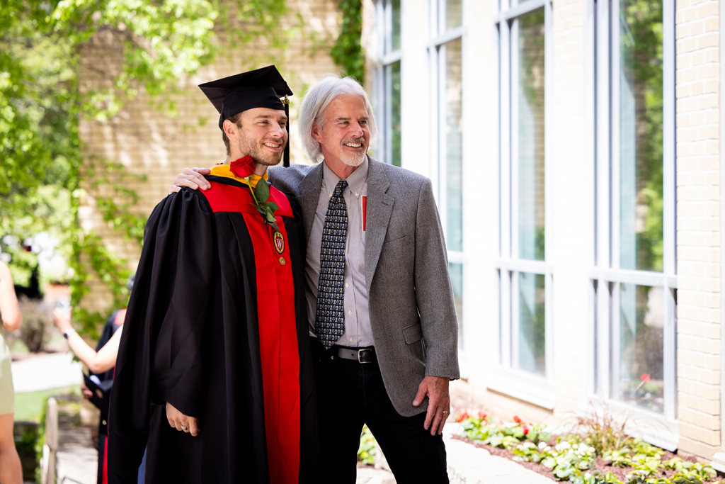 Graduates smile outside