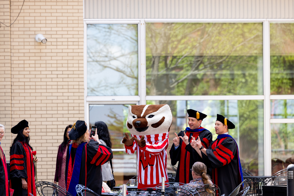 Bucky and faculty pose
